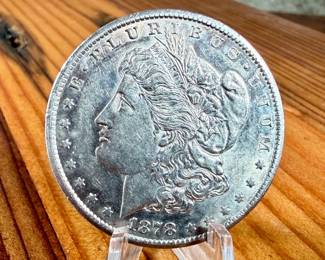 This lot features a 1878-CC Morgan Dollar. Carson City!