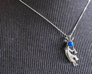 This lot features a sterling silver necklace with a “Kokopelli” pendant. Measures, 18”. 