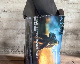 Halo Supreme Edition Master Chief costume, featuring detailed armor components and bodysuit. Includes helmet, chest piece, and other parts. Comes in its original packaging, which shows signs of wear, including creases and tears. Appears to be used and is sold as is. Ideal for collectors or cosplay enthusiasts.