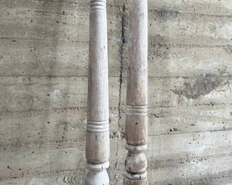 Distressed wooden architectural columns, featuring turned designs and a weathered finish indicative of their age. Each column has a square base transitioning to a detailed, rounded profile. Each measures, 96” H x 4.5” W x 4.5” D.