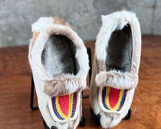 These reindeer fur slippers feature traditional Sami-style colorful decorative detailing on the front and measure, 9” heel to toe.