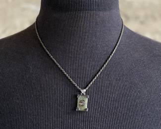 This lot features a stunning sterling silver necklace with a silver pendant wrapped around a jade stone. Measures, 20” and has a total approx. weight of 12.80 grams.