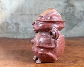 This lot features a pre-columbian style effigy vessel in good overall condition that measures, 10” H x 8” W x 7” D.