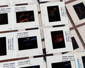 Vintage 35mm slides primarily organized in a transparent holder. Each slide features labels with the name “Richard Creamer” and addresses in Beverly Hills and Los Angeles, CA. Subjects documented include notable music acts such as Seals & Crofts and Donna Summer.