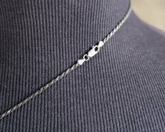 This lot features a stunning sterling silver necklace with a silver pendant wrapped around a jade stone. Measures, 20” and has a total approx. weight of 12.80 grams.