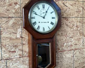 This lot features a Seth Thomas “World” model long-drop schoolhouse clock from the late 19th century.  It features a distinctive octagonal top and a long lower case for the pendulum. Tested and in good working condition with key. Measures, 32” H x 17” W.