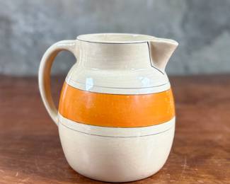 This lot features an early banded pitcher by Roseville Pottery circa 1920s or 1930s. The pitcher is in good condition and measures, 6.25” H x 7.5” W x 5.5” D.