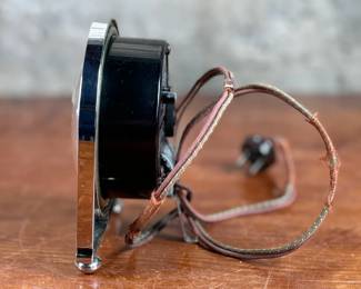 Hammond Instrument Company electric clock, made in the USA, featuring a chrome and black casing with a tan clock face and black numerals. The item includes original wiring and a two-prong plug. The back carries instructions for use and patent information. Tested and in working condition.
