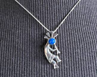 This lot features a sterling silver necklace with a “Kokopelli” pendant. Measures, 18”. 