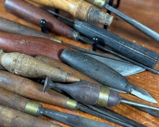 Vintage woodworking tools, including chisels and gouges with wooden handles. Some tools are marked “Buck Bros, ” known for quality craftsmanship. Handles exhibit wear consistent with age and use. The lot includes a variety of sizes and types for woodworking projects or collection purposes. Condition varies, with some minor rust and patina on metal components.
