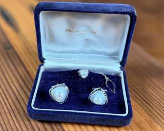 This lot features a cufflink set made of silver and housing genuine pearls.