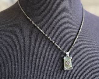 This lot features a stunning sterling silver necklace with a silver pendant wrapped around a jade stone. Measures, 20” and has a total approx. weight of 12.80 grams.