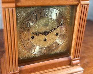 This lot features an Emperor Mantel Clock in good working condition with a key. This clock measures, 15” H x 11” W x 6” D. Franz Hermle two (2) jewel movement.