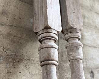 Distressed wooden architectural columns, featuring turned designs and a weathered finish indicative of their age. Each column has a square base transitioning to a detailed, rounded profile. Each measures, 96” H x 4.5” W x 4.5” D.