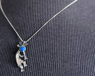 This lot features a sterling silver necklace with a “Kokopelli” pendant. Measures, 18”. 