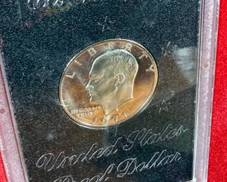 This lot features a 1971 United States Mint Eisenhower “Brown Box” Proof Dollar, which is a collectible numismatic coin. The coin is struck in a 40% silver composition.
