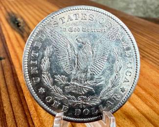 This lot features a 1878-CC Morgan Dollar.
