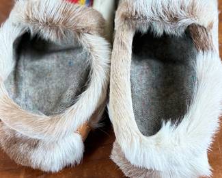 These reindeer fur slippers feature traditional Sami-style colorful decorative detailing on the front and measure, 9” heel to toe.
