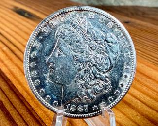 This lot features a 1887-S Morgan Dollar.