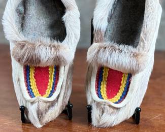These reindeer fur slippers feature traditional Sami-style colorful decorative detailing on the front and measure, 9” heel to toe.
