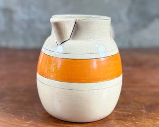 This lot features an early banded pitcher by Roseville Pottery circa 1920s or 1930s. The pitcher is in good condition and measures, 6.25” H x 7.5” W x 5.5” D.
