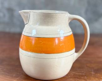 This lot features an early banded pitcher by Roseville Pottery circa 1920s or 1930s. The pitcher is in good condition and measures, 6.25” H x 7.5” W x 5.5” D.