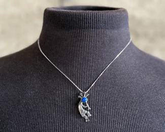 This lot features a sterling silver necklace with a “Kokopelli” pendant. Measures, 18”. 