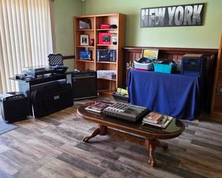 Music and audio setup with guitar amps, recording/mixing unit, turntable, and related equipment.