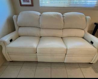 This couch is pretty new. It is a bison, leather electric couch that can be placed next to the wall and recline. It has phone hook ups. The headrest is electric and the feet are electric.
