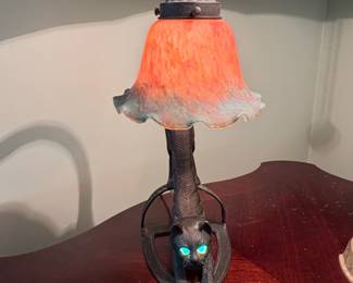 Vintage Cast Iron Crouching Cat Lamp with Glowing Green Eyes and Iridescent Glass Shade second image