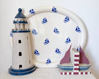 white ceramic serving platter with blue sailboat pattern, wooden lighthouse decor, wooden sailboat bookends
