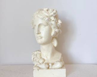 White wax sculpture of a female bust adorned with seashells