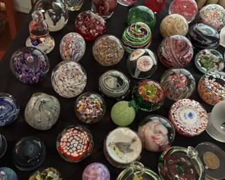 many glass paperweights from a collection