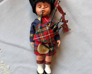 vintage Scottish souvenir doll from the 1950s or 1960s, depicting a piper in traditional Highland dress