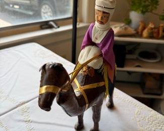 vintage handcrafted leather camel with a rider, commonly identified as a Moroccan or Egyptian souvenir figurine