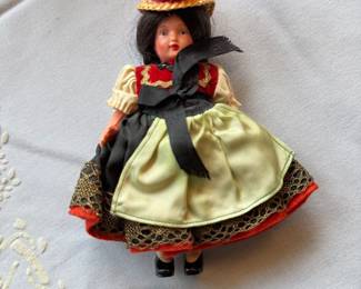 vintage German souvenir doll dressed in the traditional Black Forest "Bollenhut" costume, featuring a straw hat adorned with red pom-poms
