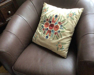 Lot 36: Brown leather armchair with embroidered cushion