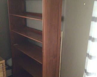 Lot 52: Tall wooden bookshelf with open shelves 