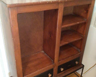Lot 53: Wooden cabinet with open storage, shelves, and drawers on a metal base