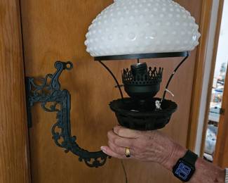 Milk glass and iron sconce