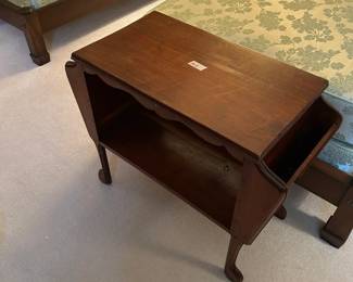 #148	end table with 2 magazine stands on the end and open shelf 32x15x21	 $75.00 			