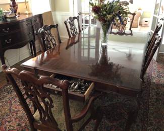 Chippendale mahogany, curved dining table accompanied by 8 carved Ethan Allen carved chairs. Chair currently being sold at Ethan Allen for $750 each. Table and chairs set $3000. Or chairs separately $2500