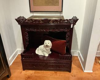Dark finished furniture with a white dog figurine