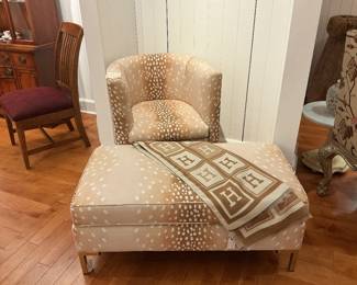 Furniture set of a swiveled barrel chair with a matching over sized ottoman