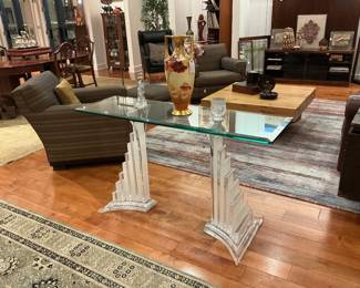 Vintage console table with a clear glass top supported by 2 agricultural bases