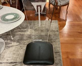 Mid Century Modern style dining chair with a black upholstered seat
