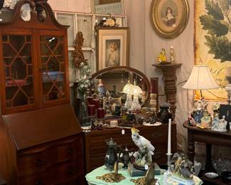 vintage green table, figurines, antique secretary, framed art, chandelier
