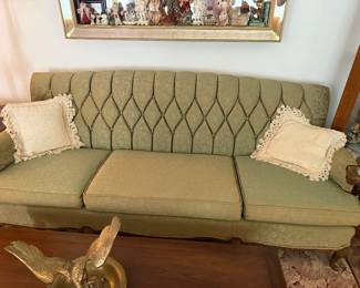  vintage green tufted sofa features a diamond-patterned backrest and intricate brocade fabric.