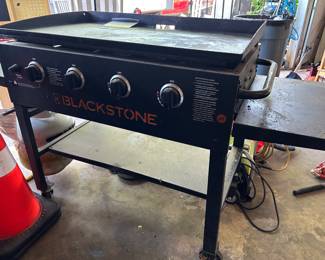 Black stone with propane tank and cover