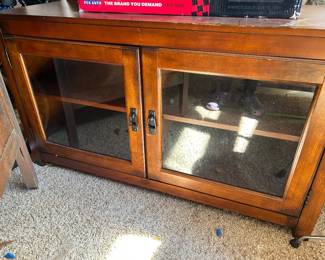 Wooden tv stand with double doors glass panel